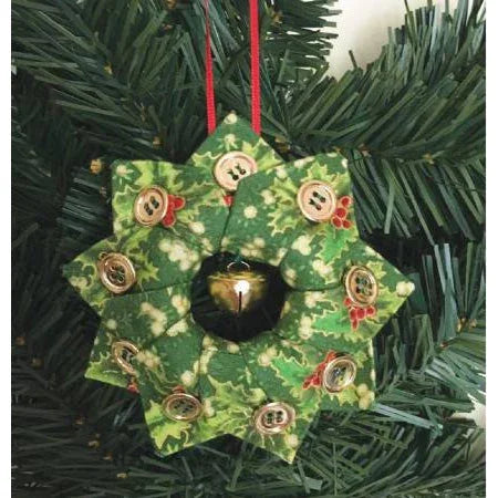 Green holiday wreath ornament with decorative buttons and starburst fabric patch