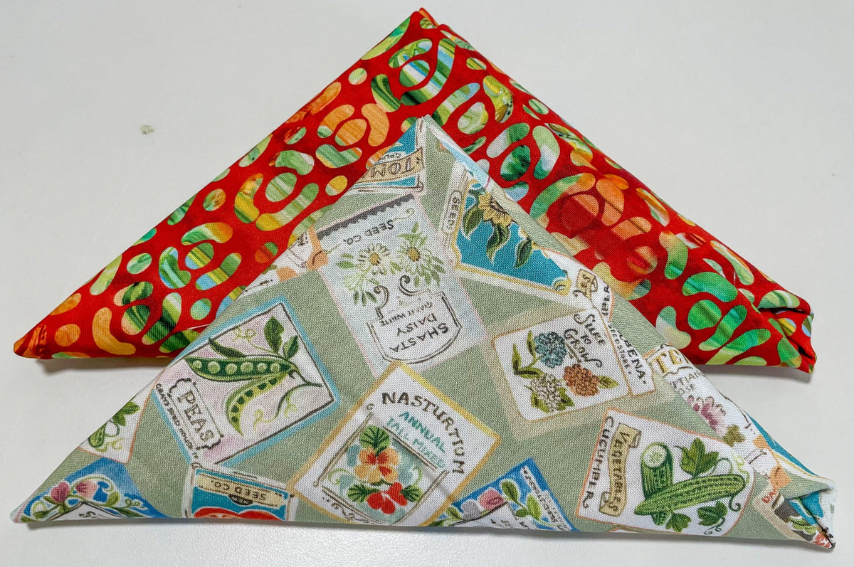 Table runner kit with red fabric and green leaf pattern, plus seed packet printed patchwork
