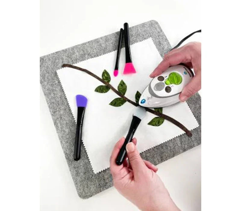 Set of quilting position and press tools with colored tips on fabric square