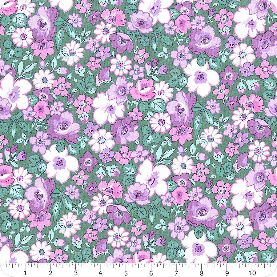 Cotton fabric swatch with pink, purple, and white floral pattern on green background