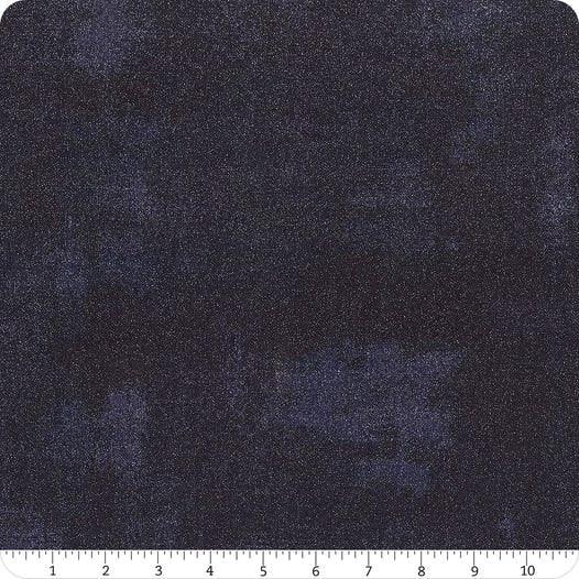 Glitter yardage fabric with dark navy speckled texture, shown with measuring ruler