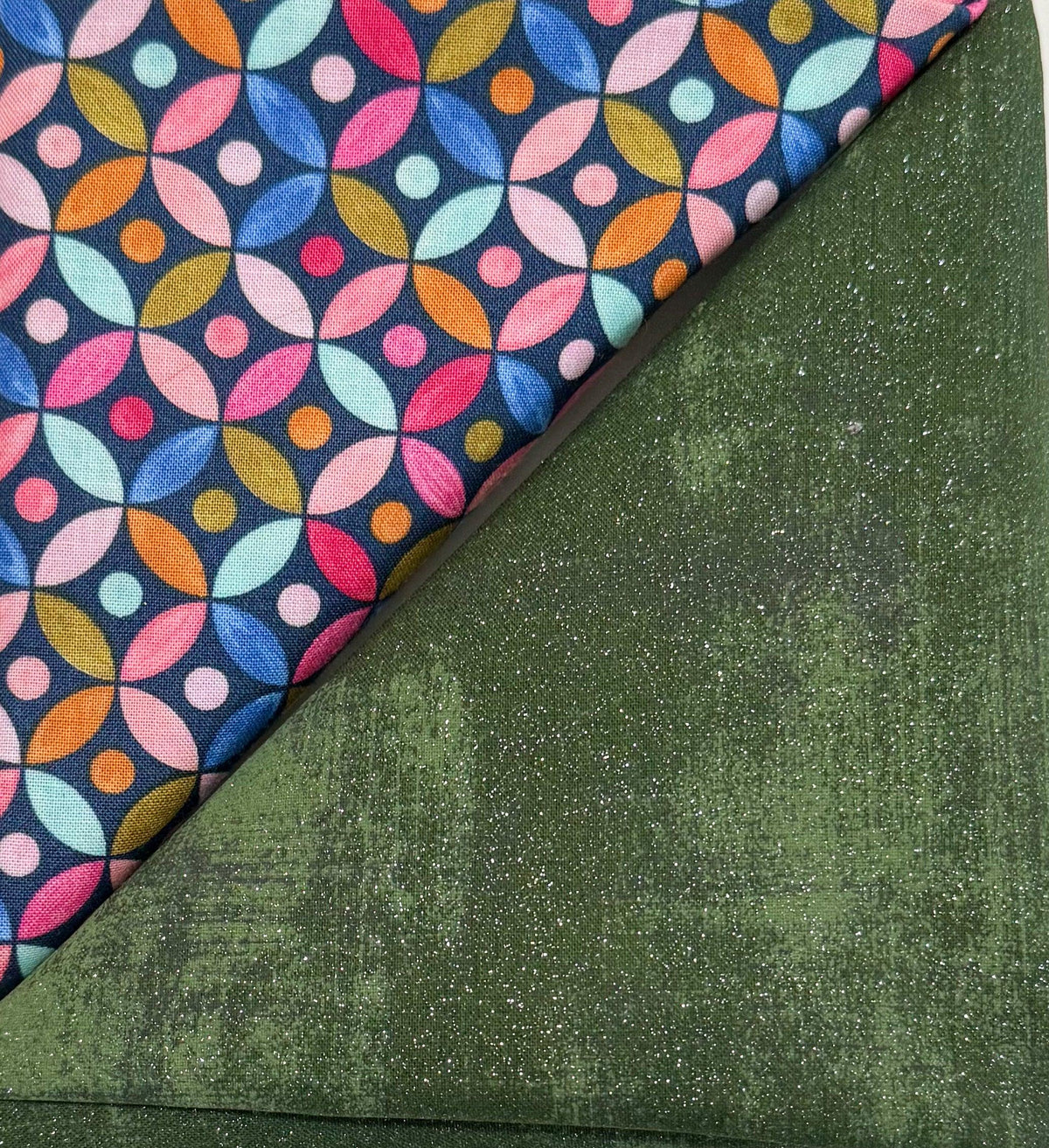 Green glitter table runner with colorful circular pattern edge