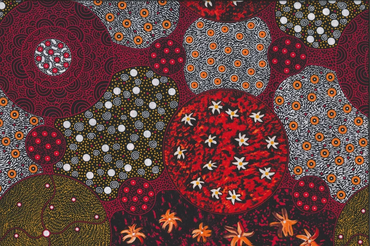Flame scarlet patterned fabric with red, orange, and green circles, dots, and stars