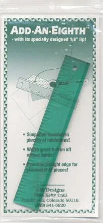 Transparent teal quilting ruler with 1-inch markings and circular hole