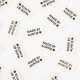 Woven clothing labels reading 'Made by Auntie' on sheet, white with blue thread