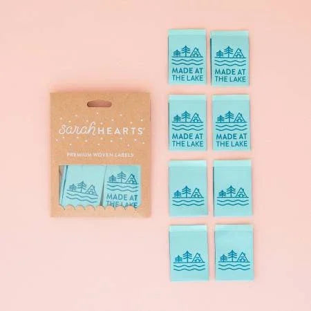 Woven clothing labels set with light blue tags and tan card, tree and wave icons