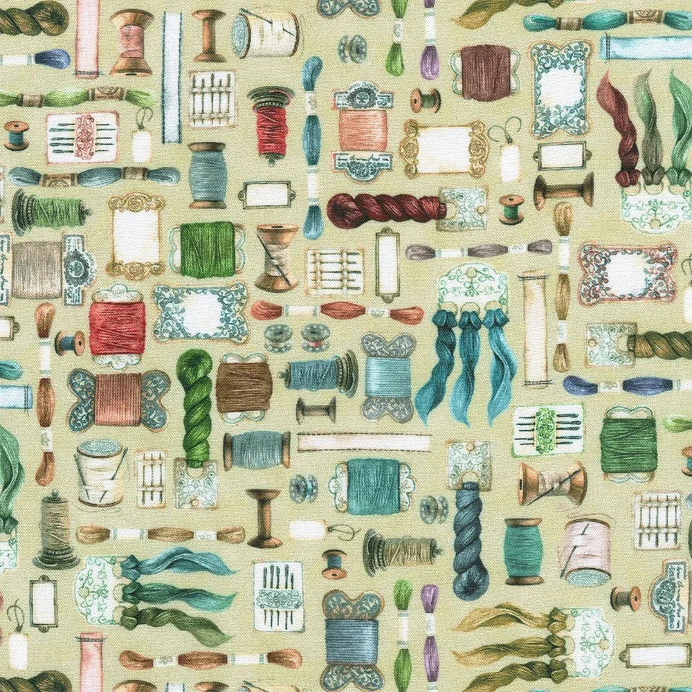 Cream sewing fabric with colorful thread spools and sewing tools