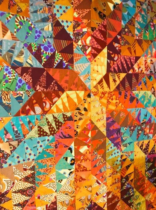 Supernova AQ890 quilt sample close-up of colorful triangle and pinwheel blocks