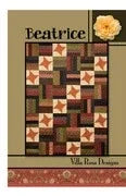Quilt pattern cover with patchwork blocks in brown, cream, red, and green