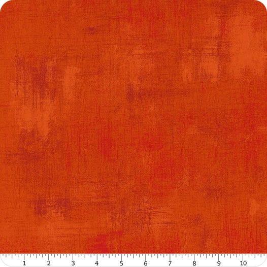 Orange grunge-style printed fabric with mottled texture swatch