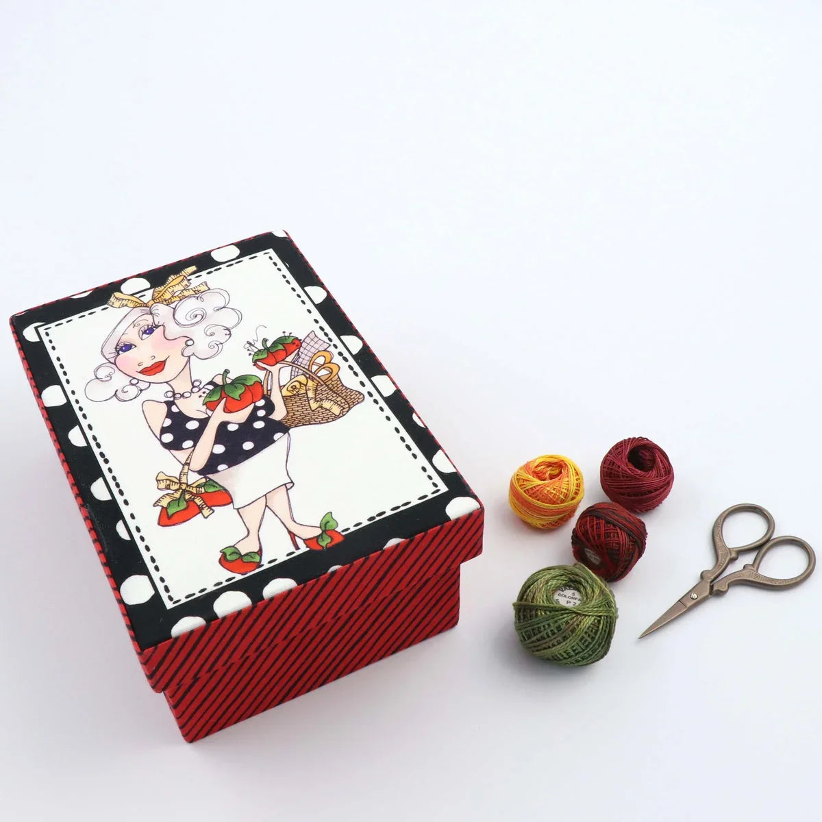 Small lidded fabric box with red striped sides and cartoon woman on the lid