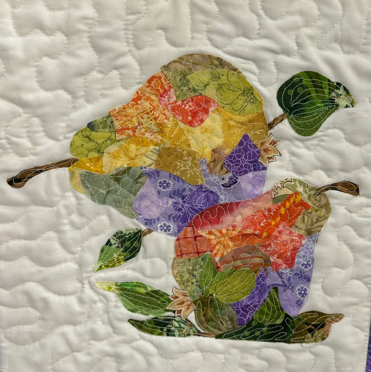 Patchwork pear collage quilt block with colorful fabric applique leaves and pears