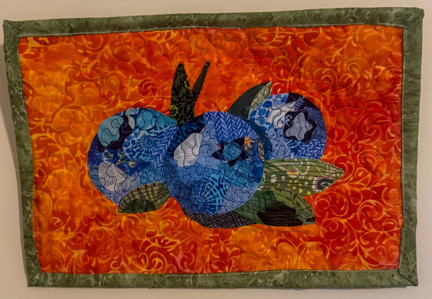 Samantha's Blueberries collage hardcopy: orange panel with blue shapes and leaves