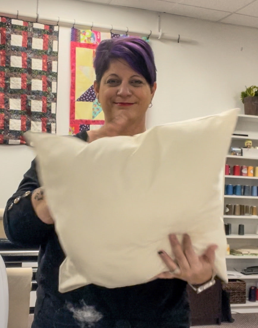 Ivory pillow form with two soft, rectangular cushions held up