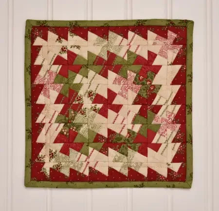 Red, white, and green pinwheel quilt block with zigzag patchwork, square