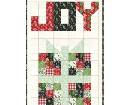 Patchwork quilt top with red, green, and white squares in a grid pattern