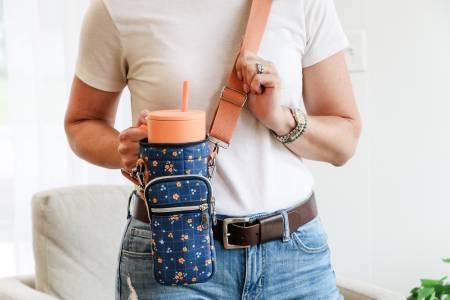 Water tumbler carrier bag with adjustable crossbody strap and zipper pockets