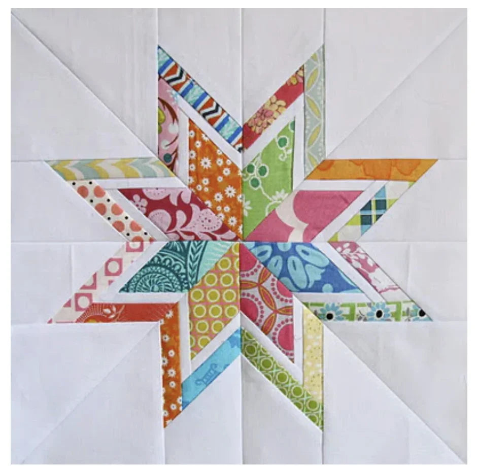 Starburst quilt block with multicolor fabric triangles on white background