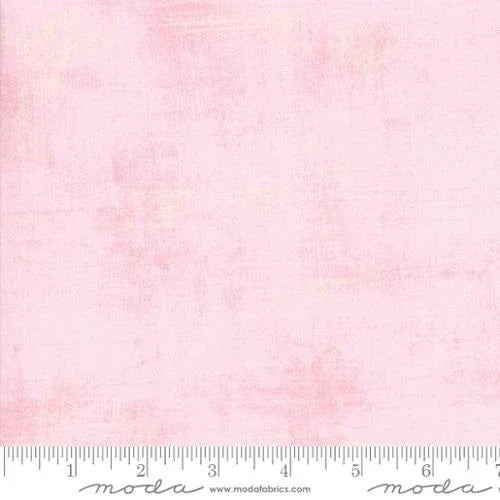 Pink fabric swatch with printed ruler edge