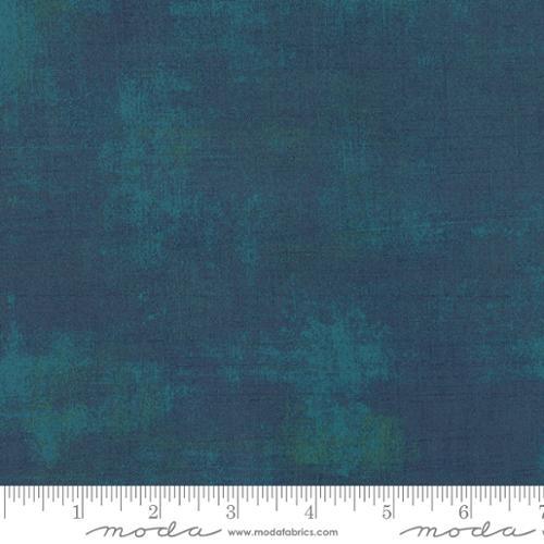 Textured grunge fabric swatch with mottled blue-green tone