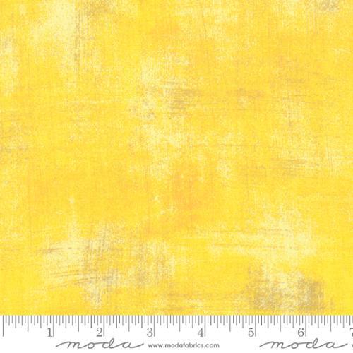 Yellow grunge-textured fabric with subtle distressed pattern