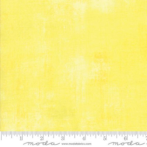 Lemon yellow fabric swatch with selvage edge, shown with measurement ruler