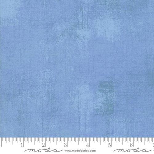Powder blue grunge cotton fabric with distressed texture and selvedge edge