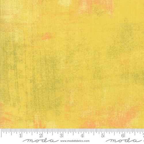 Grunge texture cotton fabric in curry yellow with orange speckles