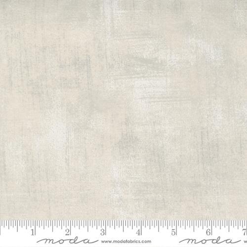 Beige printed fabric swatch with scattered grunge pattern