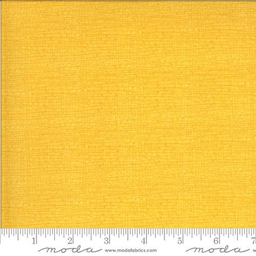 Thatched buttercup yellow cotton fabric with subtle woven texture