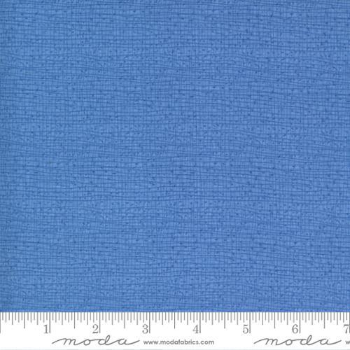 Woven cotton fabric swatch in cornflower blue with tight textured surface