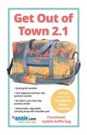 Multicolor patterned fabric duffle bag with blue trim, front pouch and shoulder strap.