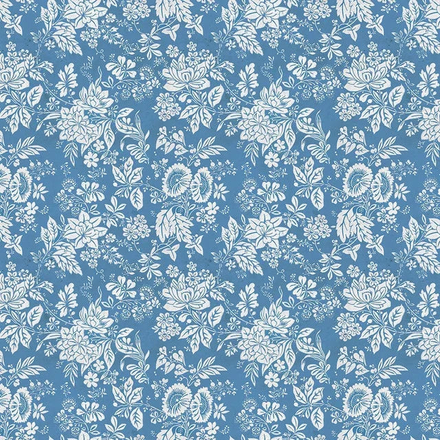 Blue tapestry fabric with white floral vines and small circular blooms