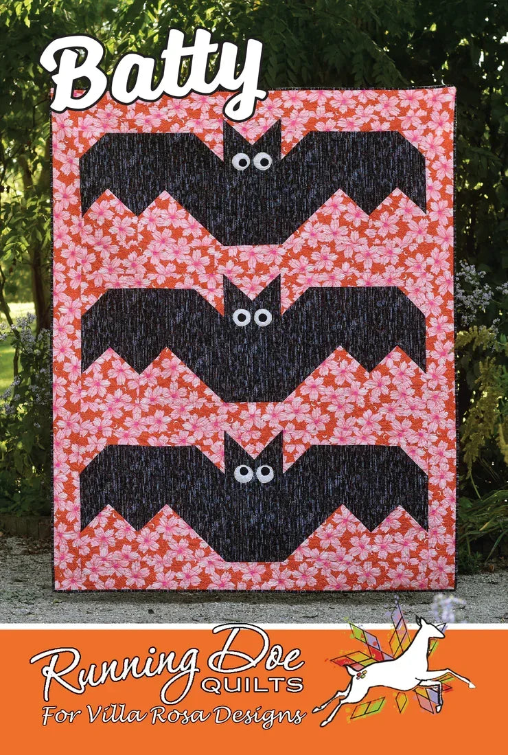 Quilt with black and pink batty zigzag patchwork, chevron design and bow accents