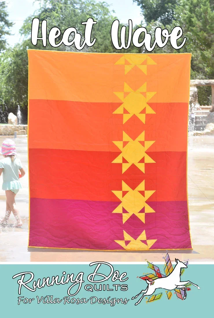 Heat Wave quilt with orange, pink, and purple panels and yellow star block pattern