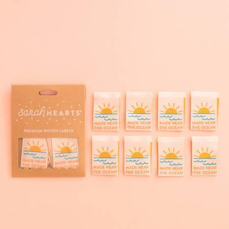 Ocean-themed woven clothing labels, rectangular set with sun and wave icons