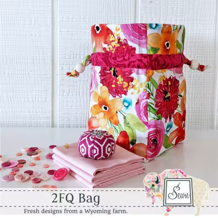 Patchwork fabric bag with quilted handles and colorful floral print