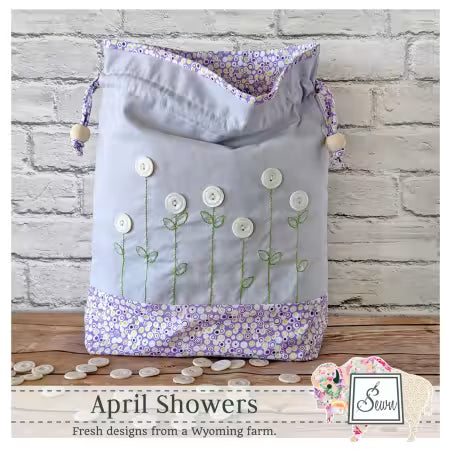 Lavender floral drawstring bag with button accents and wooden bead cords