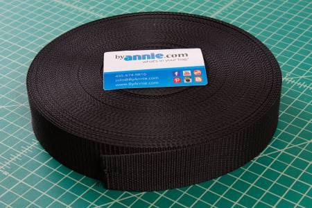 Black polypro strapping roll on spool, woven fabric tape with label