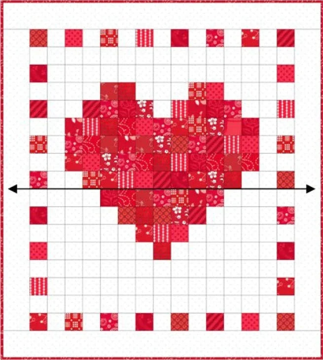 Red-and-white patchwork quilt with central heart and border of checker blocks