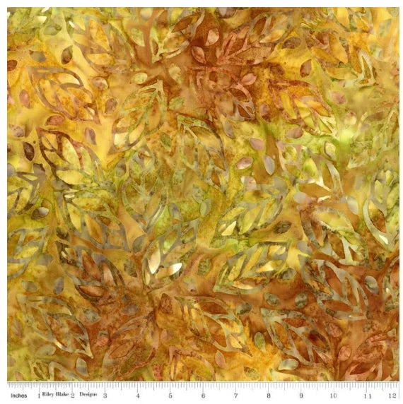 Floral batik fabric with leaf-like motifs in gold, green, and rust tones