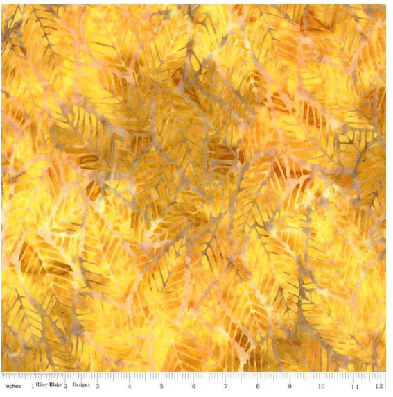 Batik quilt fabric with goldenrod floral and leaf reflections pattern