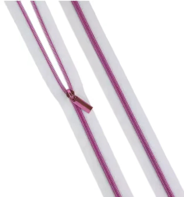 Nylon coil zipper tape with magenta coils and matching pull