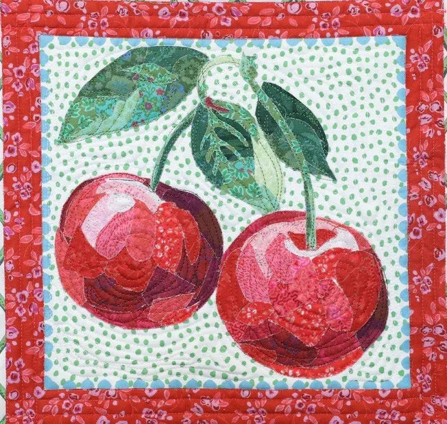Cherry and leaf fabric patchwork square with red cherries, green leaves, and dotted background