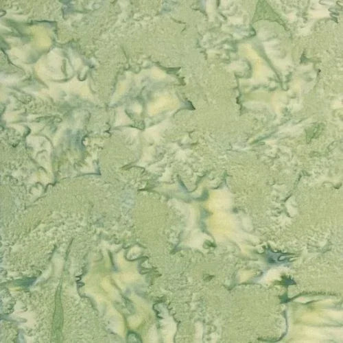 Light green batik yardage fabric with leafy swirls and mottled texture