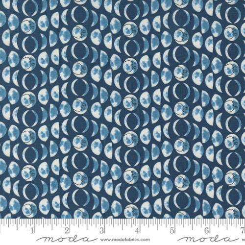Blue cotton fabric with moon-and-star pattern for quilting and crafts.