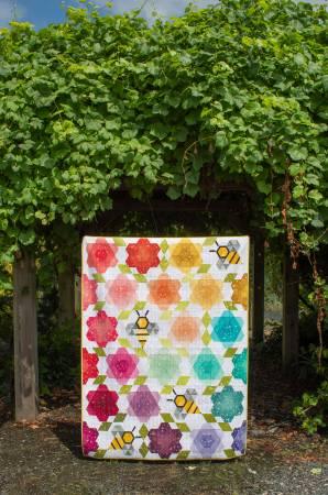 Multicolor quilt with floral geometric blocks and honeycomb motifs in a framed panel