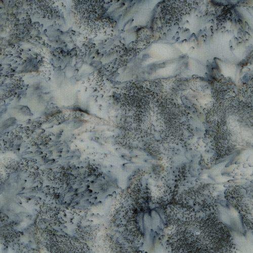 Blue and gray batik fabric yardage with abstract speckled pattern.