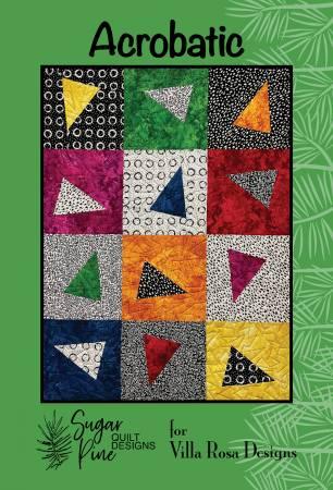 Quilt pattern featuring patchwork squares with multicolor triangular blocks