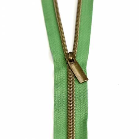 Nylon coil zipper in green with antique metal pull tab and teeth.